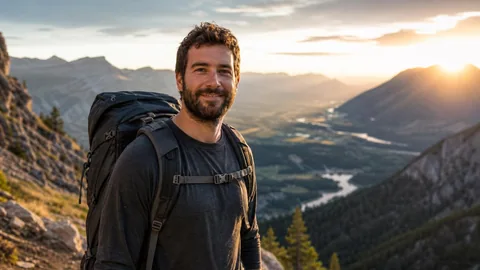 Hiker with a backpack on a mountain trail at golden hour