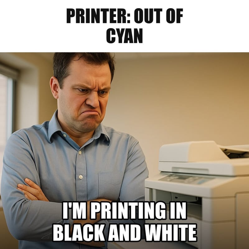A man in an office glaring at a beige office printer with pure contempt, arms crossed, the printer's paper tray empty. Caption: "Printer: out of cyan I'm printing in black and white"
